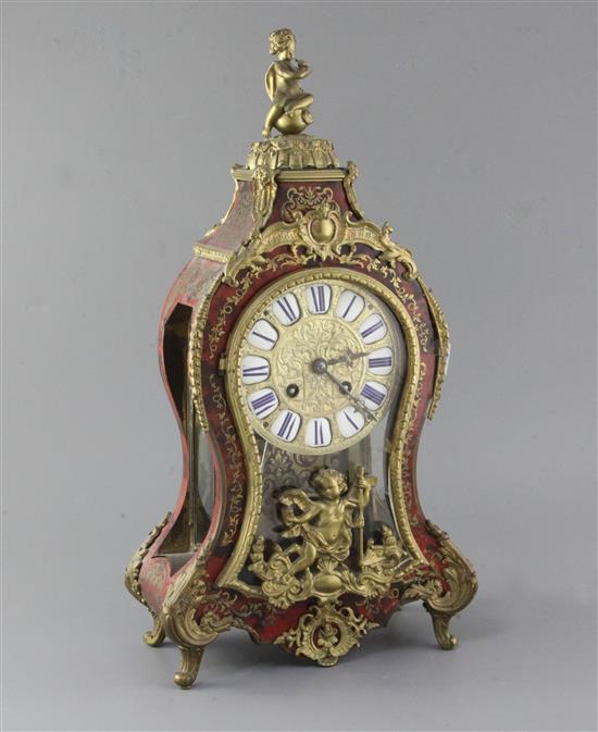 An early 20th century ormolu and red boulle Louis XVI style mantel clock, 19in.